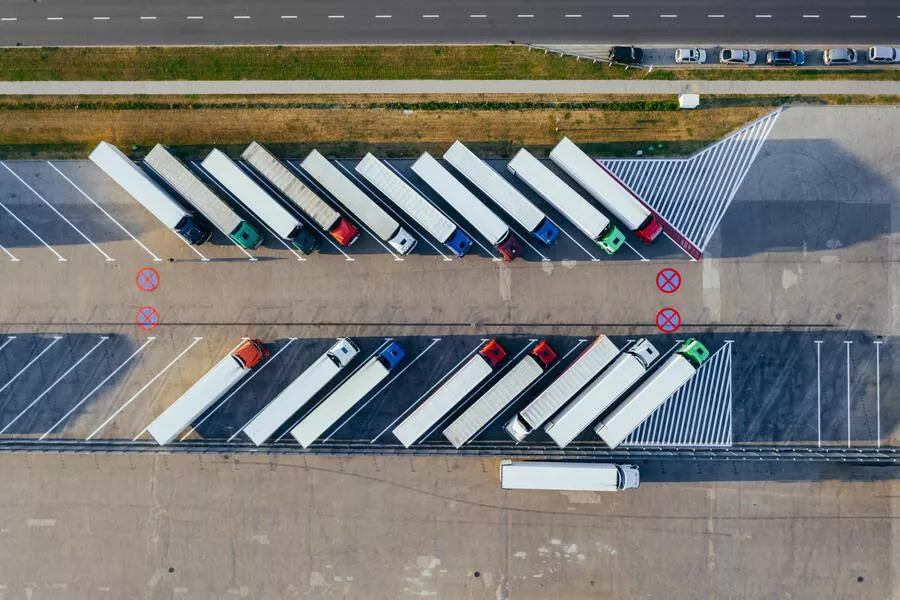 Aerial shot of semi trucks in a parking log