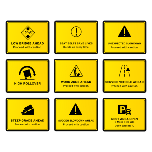 Nine yellow road signs with warnings: low bridge, seat belts, slowdown, high rollover, work zone, service vehicle, steep grade, sudden slowdown, and rest area with open spaces. All advise truckers to proceed with caution in their journey.
