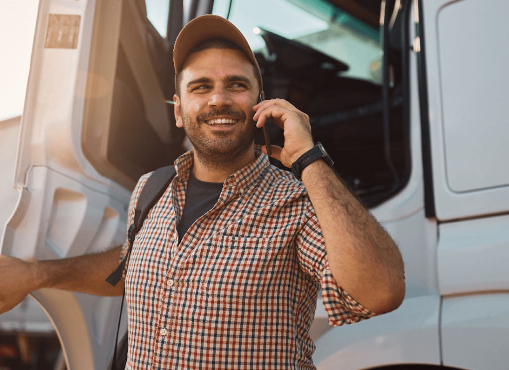 Owner-operator of 1-15 trucks talking on a cell phone